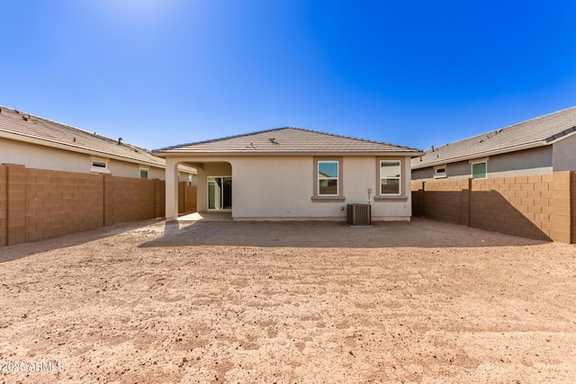 rear view of house with a patio and cooling unit