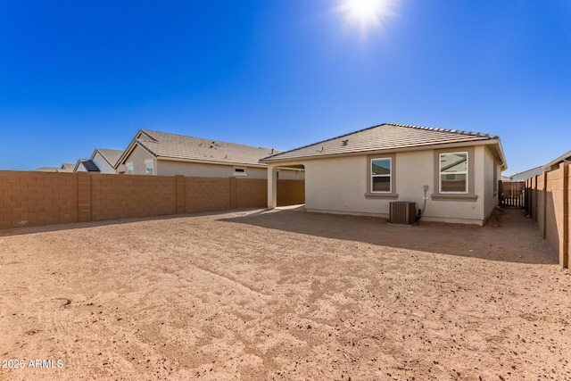 rear view of property featuring cooling unit