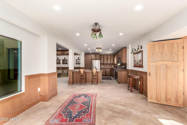 8752 E Range Rider Trl, Mesa, AZ 85207 - living room featuring a wainscoted wall, recessed lighting, and wood walls