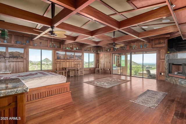 8752 E Range Rider Trl, Mesa, AZ 85207 - bedroom with coffered ceiling, beam ceiling, hardwood / wood-style floors, wood walls, and a fireplace
