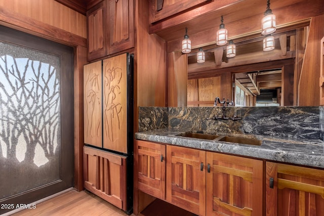 8752 E Range Rider Trl, Mesa, AZ 85207 - kitchen with a sink, brown cabinetry, fridge, and dark stone counters