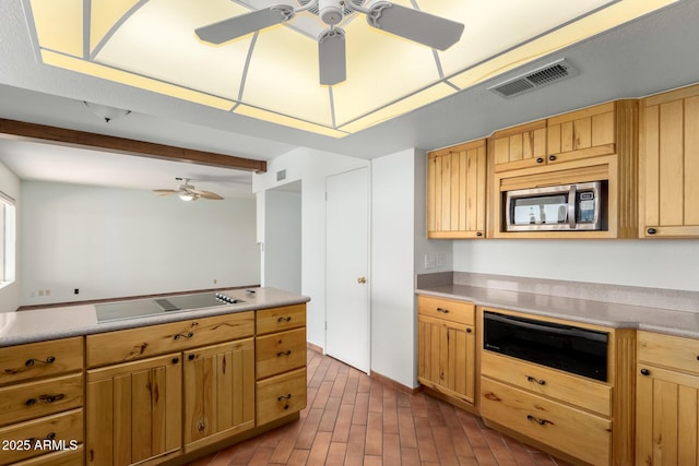 8752 E Range Rider Trl, Mesa, AZ 85207 - kitchen with a ceiling fan, stainless steel microwave, beam ceiling, a warming drawer, and black electric stovetop