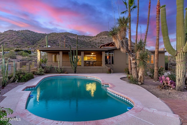 8752 E Range Rider Trl, Mesa, AZ 85207 - pool at dusk with a mountain view and a patio