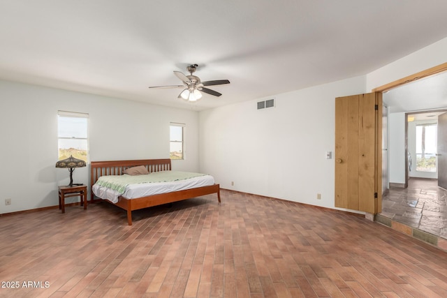 8752 E Range Rider Trl, Mesa, AZ 85207 - bedroom with light wood-style floors, a ceiling fan, and baseboards