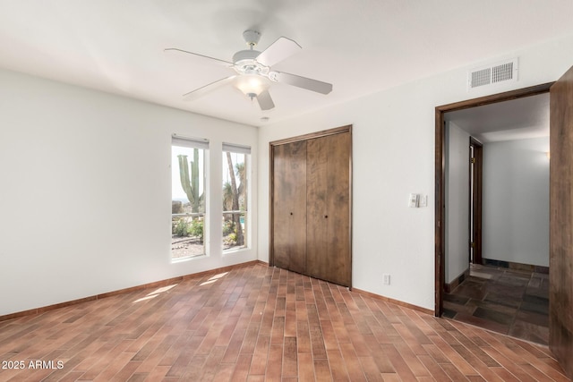 8752 E Range Rider Trl, Mesa, AZ 85207 - unfurnished bedroom with wood finished floors, a closet, baseboards, and ceiling fan