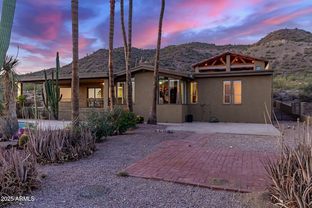 8752 E Range Rider Trl, Mesa, AZ 85207 - rear view of house featuring stucco siding, a mountain view, and a patio