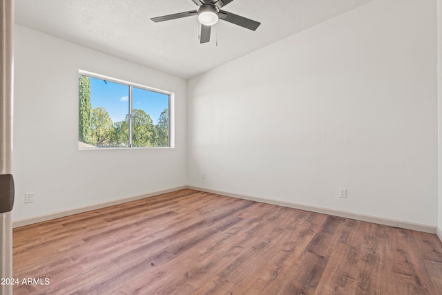 spare room with hardwood / wood-style floors and ceiling fan