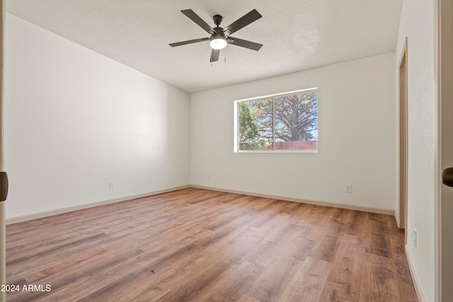 spare room featuring light hardwood / wood-style flooring and ceiling fan