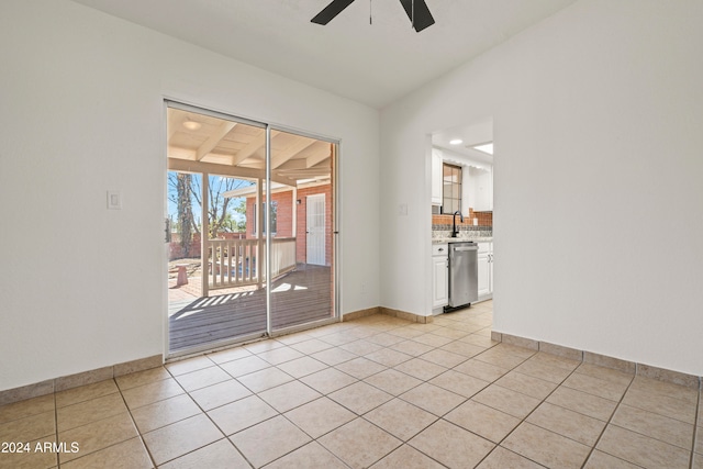 tiled spare room featuring vaulted ceiling and ceiling fan