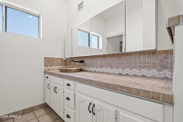 bathroom featuring decorative backsplash, vanity, and tile patterned floors