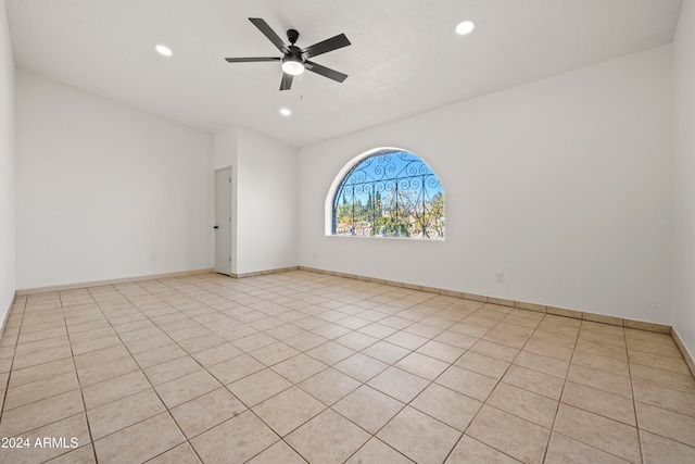 tiled empty room with ceiling fan