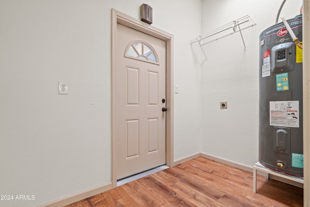 entryway with hardwood / wood-style floors and water heater