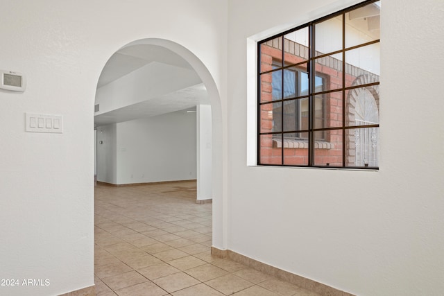 hall featuring light tile patterned flooring