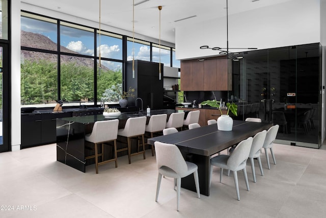 dining space with light tile patterned floors and a high ceiling