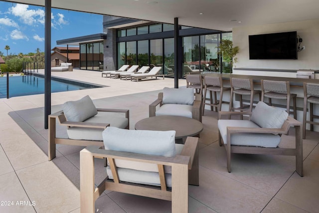 view of patio featuring an outdoor living space, an outdoor pool, and outdoor dry bar