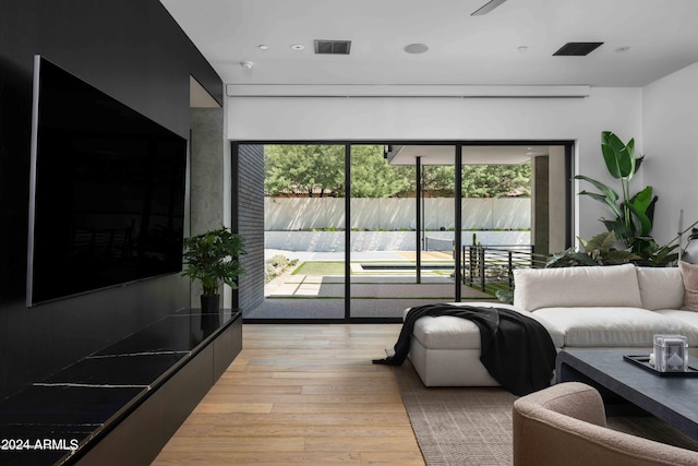 living area with visible vents, light wood finished floors, and recessed lighting