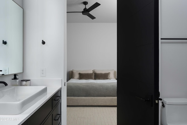 bathroom featuring vanity, a ceiling fan, and toilet