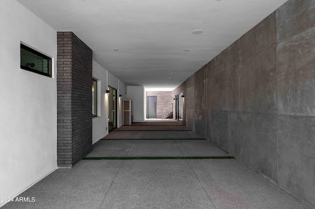 corridor featuring speckled floor