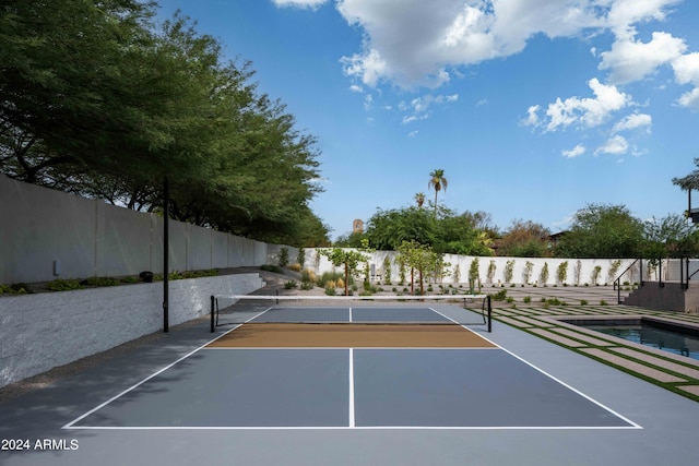 view of sport court featuring community basketball court and fence