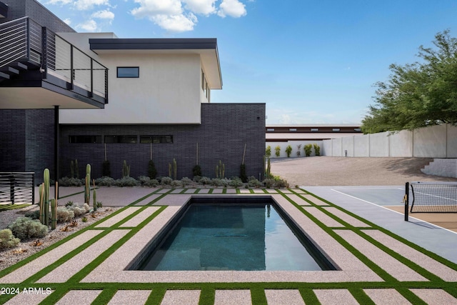 view of swimming pool with a fenced in pool and fence