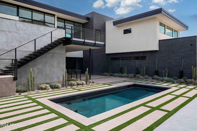 view of swimming pool featuring stairs and a patio area