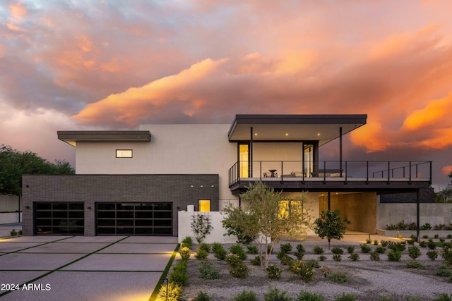 modern home featuring driveway, stucco siding, and an attached garage