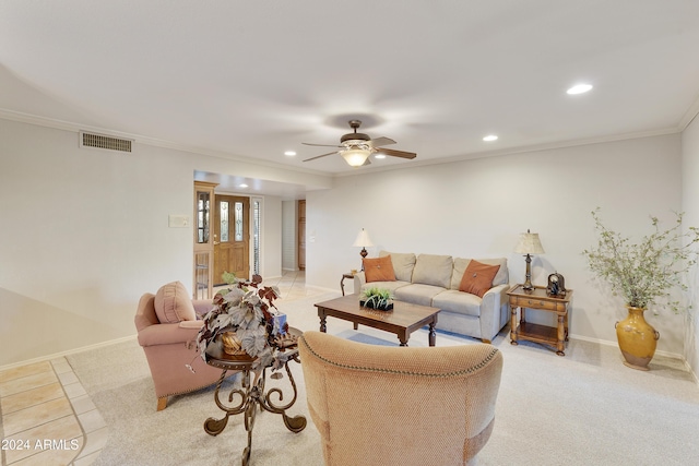 tiled living room with ceiling fan and ornamental molding