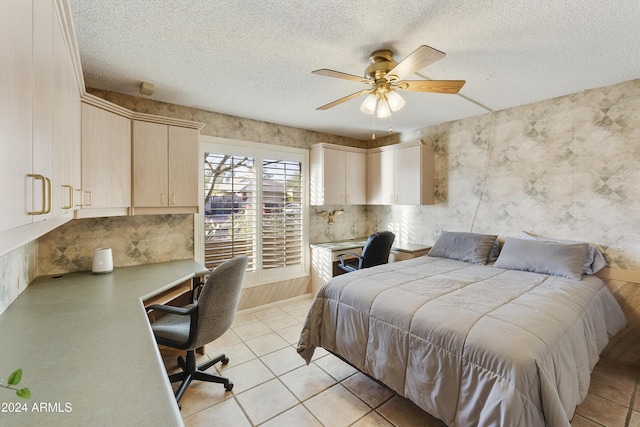 tiled bedroom with ceiling fan and a textured ceiling