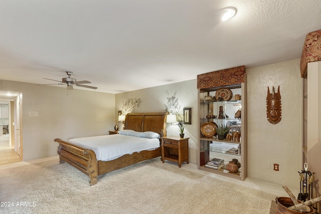 bedroom featuring ceiling fan and light carpet