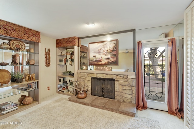 living room featuring a stone fireplace and light colored carpet