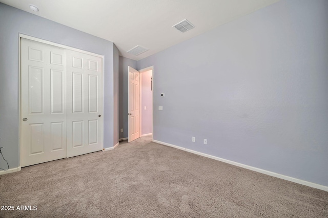 unfurnished bedroom featuring a closet, baseboards, visible vents, and carpet flooring