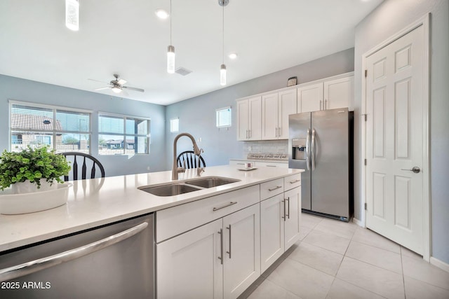 kitchen featuring white cabinetry, appliances with stainless steel finishes, and light countertops