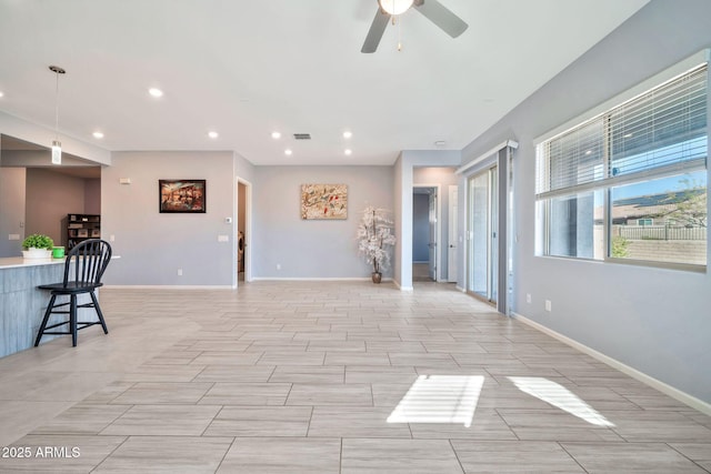 spare room featuring baseboards, a ceiling fan, and recessed lighting