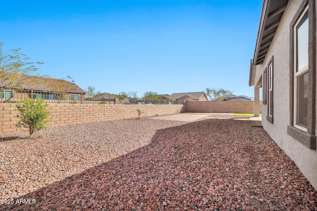 view of yard with a fenced backyard and a patio