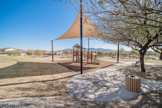 view of property's community featuring playground community and a mountain view