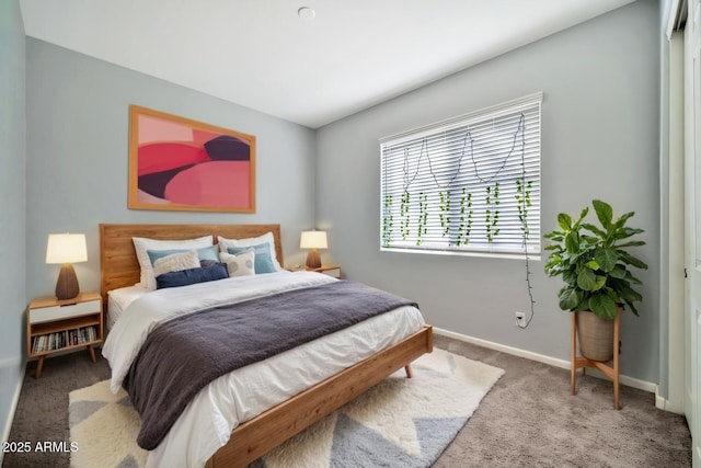 carpeted bedroom featuring baseboards