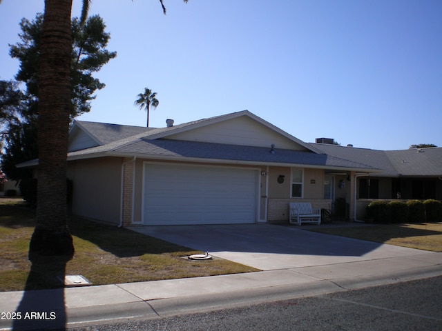 view of front of house featuring concrete driveway, brick siding, and an attached garage