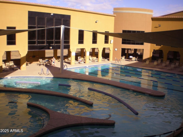 community pool with a patio and a jacuzzi