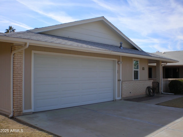 view of property exterior featuring a garage, concrete driveway, brick siding, and a shingled roof