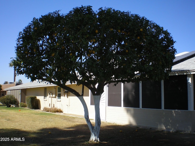 view of property exterior featuring a lawn