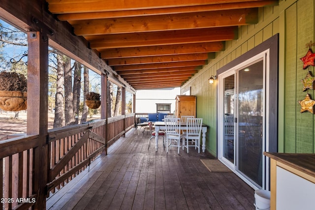 wooden terrace with outdoor dining area