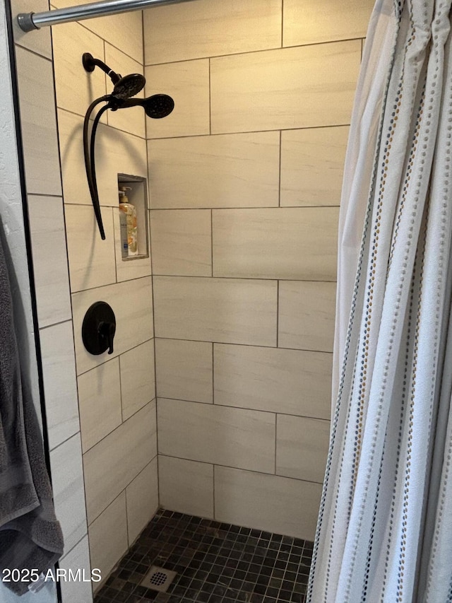 bathroom with a tile shower