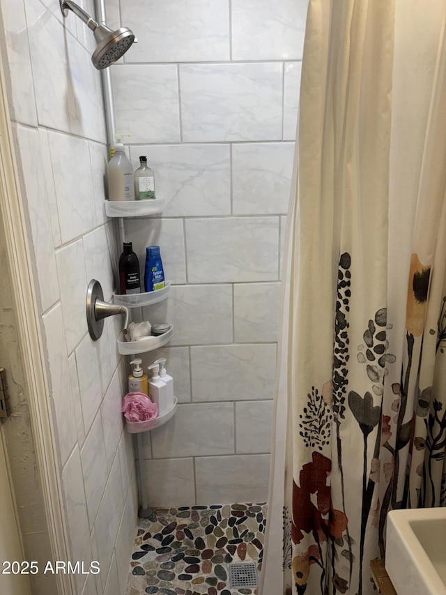 full bath with a tile shower