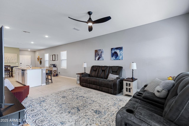 living room with visible vents, ceiling fan, baseboards, and light tile patterned floors