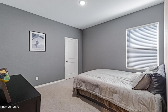 bedroom featuring carpet and baseboards