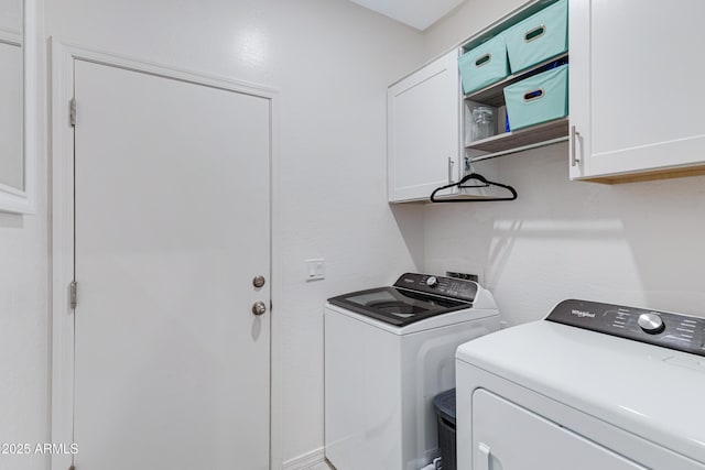 clothes washing area with cabinet space and washing machine and dryer