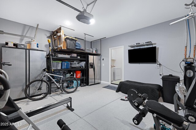 workout room featuring a garage and washing machine and dryer