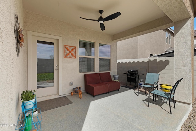 view of patio / terrace featuring a grill, fence, and ceiling fan