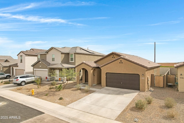 view of front of home with stucco siding, a garage, a residential view, driveway, and a tiled roof