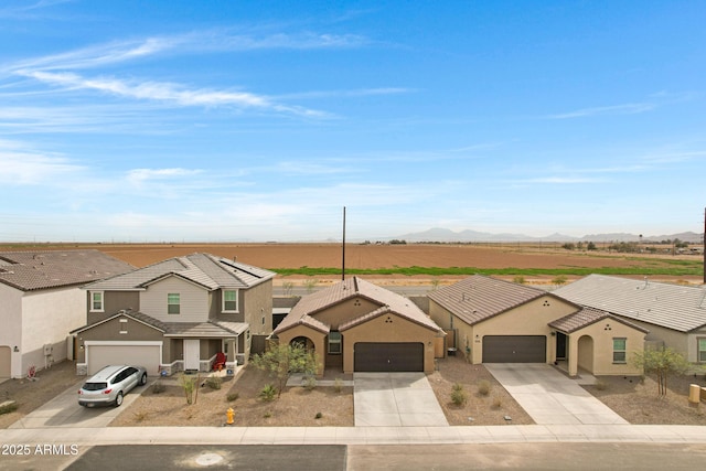 view of front of home with driveway, a tile roof, a residential view, and stucco siding